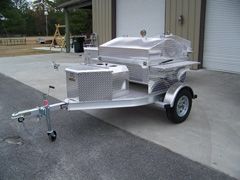 Front view of barbecue trailer with storage box and propane tank cover 